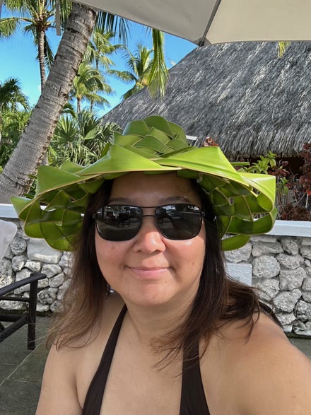 Wan Hutchinson in sunglasses and a woven palm-leaf hat